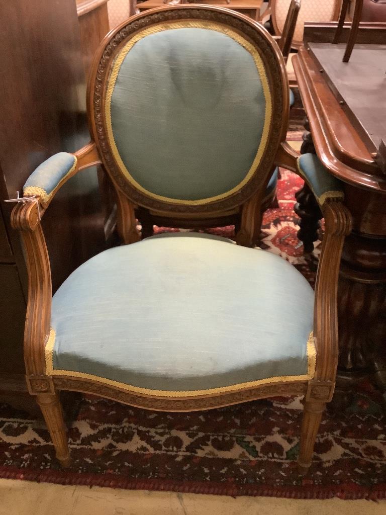 A pair of Louis XVI style carved and stained and beech fauteuils, width 60cm, depth 55cm, height 92cm